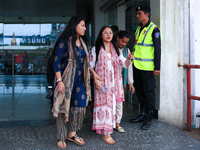 Krishpa Rai (center) along with other Nepali students are exiting the terminal of Tribhuvan International Airport upon arriving back in Kath...