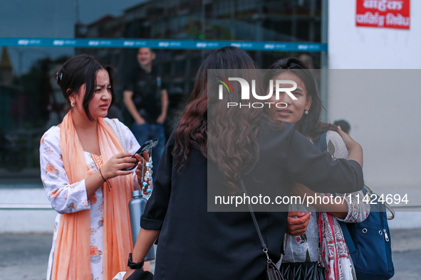 A Nepali student who is returning to Nepal from violence-hit Bangladesh is hugging her relative upon arrival at Tribhuvan International Airp...