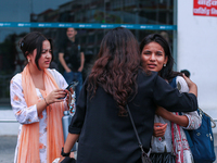 A Nepali student who is returning to Nepal from violence-hit Bangladesh is hugging her relative upon arrival at Tribhuvan International Airp...