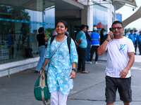 A Nepali student who is arriving back from violence-hit Bangladesh is walking alongside her father towards the vehicle after arriving at Tri...