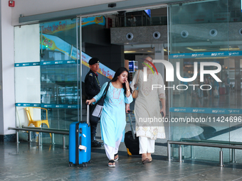 Nepali students are exiting the terminal of Tribhuvan International Airport upon arriving back in Kathmandu, Nepal, from violence-hit Bangla...