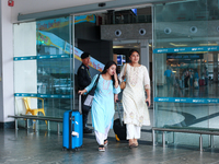 Nepali students are exiting the terminal of Tribhuvan International Airport upon arriving back in Kathmandu, Nepal, from violence-hit Bangla...