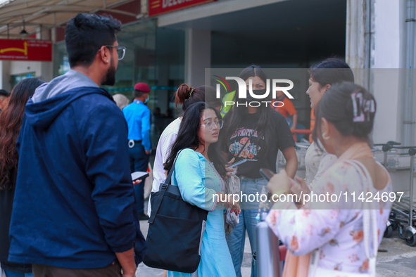 A Nepali student who is returning to Nepal from violence-hit Bangladesh is hugging her relative upon arrival at Tribhuvan International Airp...