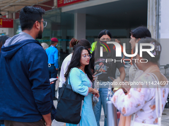 A Nepali student who is returning to Nepal from violence-hit Bangladesh is hugging her relative upon arrival at Tribhuvan International Airp...