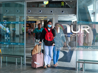 Nepali students are exiting the terminal of Tribhuvan International Airport upon arriving back in Kathmandu, Nepal, from violence-hit Bangla...