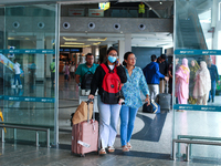 Nepali students are exiting the terminal of Tribhuvan International Airport upon arriving back in Kathmandu, Nepal, from violence-hit Bangla...