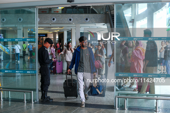 Nepali students are exiting the terminal of Tribhuvan International Airport upon arriving back in Kathmandu, Nepal, from violence-hit Bangla...