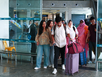 Nepali students are exiting the terminal of Tribhuvan International Airport upon arriving back in Kathmandu, Nepal, from violence-hit Bangla...