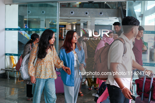 Nepali students are exiting the terminal of Tribhuvan International Airport upon arriving back in Kathmandu, Nepal, from violence-hit Bangla...