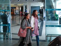 Nepali students are exiting the terminal of Tribhuvan International Airport upon arriving back in Kathmandu, Nepal, from violence-hit Bangla...