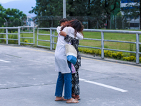 A Nepali student who is returning to Nepal from violence-hit Bangladesh is hugging her relative upon arrival at Tribhuvan International Airp...