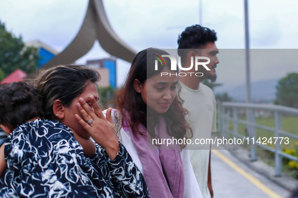 A Nepali student who is returning to Nepal from violence-hit Bangladesh is hugging her relative upon arrival at Tribhuvan International Airp...