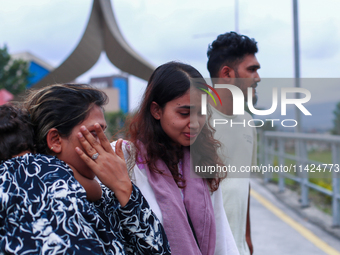 A Nepali student who is returning to Nepal from violence-hit Bangladesh is hugging her relative upon arrival at Tribhuvan International Airp...