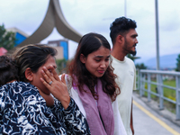 A Nepali student who is returning to Nepal from violence-hit Bangladesh is hugging her relative upon arrival at Tribhuvan International Airp...