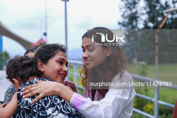 A Nepali student who is returning to Nepal from violence-hit Bangladesh is hugging her relative upon arrival at Tribhuvan International Airp...