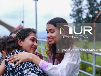 A Nepali student who is returning to Nepal from violence-hit Bangladesh is hugging her relative upon arrival at Tribhuvan International Airp...