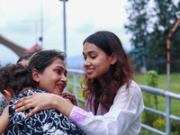 A Nepali student who is returning to Nepal from violence-hit Bangladesh is hugging her relative upon arrival at Tribhuvan International Airp...