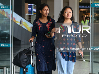 Nepali students are exiting the terminal of Tribhuvan International Airport upon arriving back in Kathmandu, Nepal, from violence-hit Bangla...