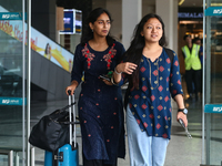 Nepali students are exiting the terminal of Tribhuvan International Airport upon arriving back in Kathmandu, Nepal, from violence-hit Bangla...