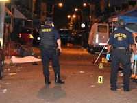 The crime scene unit is at the scene of a mass shooting with evidence markers placed on the ground, in Philadelphia, Pennsylvania, on July 2...