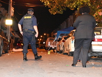 The crime scene unit is at the scene of a mass shooting with evidence markers placed on the ground, in Philadelphia, Pennsylvania, on July 2...