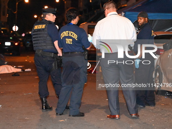 The crime scene unit is at the scene of a mass shooting with evidence markers placed on the ground, in Philadelphia, Pennsylvania, on July 2...