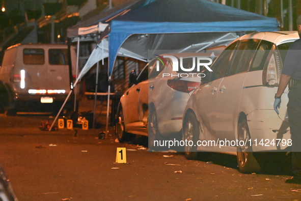 The crime scene unit is at the scene of a mass shooting with evidence markers placed on the ground, in Philadelphia, Pennsylvania, on July 2...