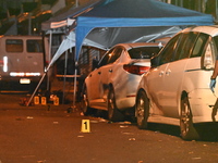 The crime scene unit is at the scene of a mass shooting with evidence markers placed on the ground, in Philadelphia, Pennsylvania, on July 2...