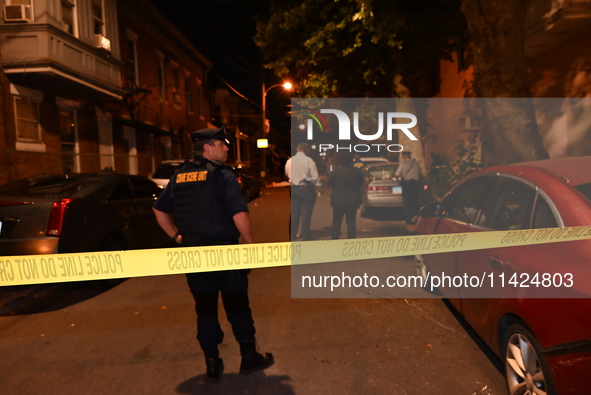 The crime scene unit is at the scene of a mass shooting with evidence markers placed on the ground, in Philadelphia, Pennsylvania, on July 2...