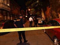 The crime scene unit is at the scene of a mass shooting with evidence markers placed on the ground, in Philadelphia, Pennsylvania, on July 2...