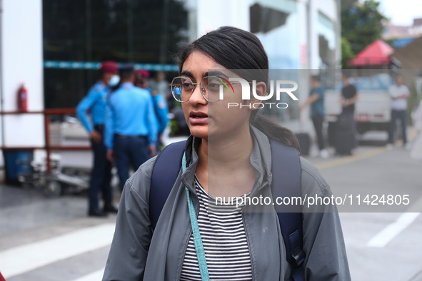 Sushmita Kumari, a Nepali student, is getting emotional while talking with her relatives upon arrival at Tribhuvan International Airport in...