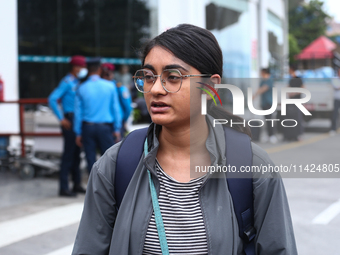 Sushmita Kumari, a Nepali student, is getting emotional while talking with her relatives upon arrival at Tribhuvan International Airport in...