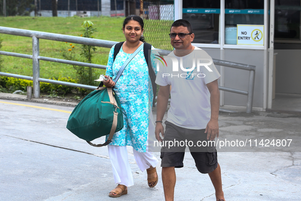 Nepali students are exiting the terminal of Tribhuvan International Airport upon arriving back in Kathmandu, Nepal, from violence-hit Bangla...