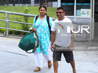 Nepali students are exiting the terminal of Tribhuvan International Airport upon arriving back in Kathmandu, Nepal, from violence-hit Bangla...