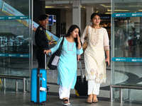 Nepali students are exiting the terminal of Tribhuvan International Airport upon arriving back in Kathmandu, Nepal, from violence-hit Bangla...