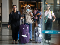 Nepali students are exiting the terminal of Tribhuvan International Airport upon arriving back in Kathmandu, Nepal, from violence-hit Bangla...