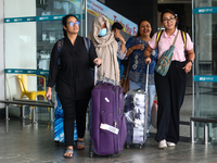 Nepali students are exiting the terminal of Tribhuvan International Airport upon arriving back in Kathmandu, Nepal, from violence-hit Bangla...