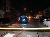 The crime scene unit is at the scene of a mass shooting with evidence markers placed on the ground, in Philadelphia, Pennsylvania, on July 2...