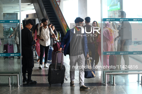 Nepali students are exiting the terminal of Tribhuvan International Airport upon arriving back in Kathmandu, Nepal, from violence-hit Bangla...