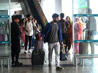 Nepali students are exiting the terminal of Tribhuvan International Airport upon arriving back in Kathmandu, Nepal, from violence-hit Bangla...