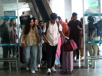 Nepali students are exiting the terminal of Tribhuvan International Airport upon arriving back in Kathmandu, Nepal, from violence-hit Bangla...