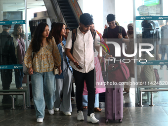 Nepali students are exiting the terminal of Tribhuvan International Airport upon arriving back in Kathmandu, Nepal, from violence-hit Bangla...