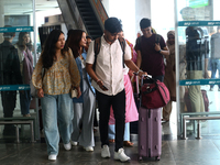 Nepali students are exiting the terminal of Tribhuvan International Airport upon arriving back in Kathmandu, Nepal, from violence-hit Bangla...