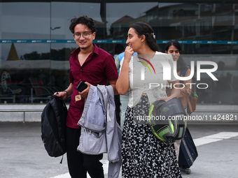 Nepali students are exiting the terminal of Tribhuvan International Airport upon arriving back in Kathmandu, Nepal, from violence-hit Bangla...