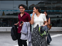 Nepali students are exiting the terminal of Tribhuvan International Airport upon arriving back in Kathmandu, Nepal, from violence-hit Bangla...