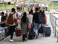 Nepali students are exiting the terminal of Tribhuvan International Airport upon arriving back in Kathmandu, Nepal, from violence-hit Bangla...