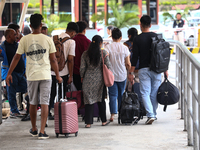 Nepali students are exiting the terminal of Tribhuvan International Airport upon arriving back in Kathmandu, Nepal, from violence-hit Bangla...