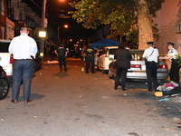 The crime scene unit is at the scene of a mass shooting with evidence markers placed on the ground, in Philadelphia, Pennsylvania, on July 2...