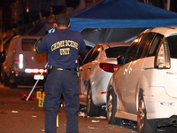 The crime scene unit is at the scene of a mass shooting with evidence markers placed on the ground, in Philadelphia, Pennsylvania, on July 2...