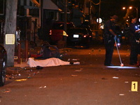 The crime scene unit is at the scene of a mass shooting with evidence markers placed on the ground, in Philadelphia, Pennsylvania, on July 2...